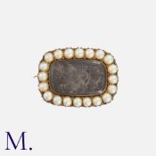A Pearl And Hairwork Mourning Brooch in yellow gold, set with a woven hairwork within a border of