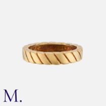 VAN CLEEF & ARPELS. A Gold Band in 18K yellow gold with rope-work design. Signed VCA and serial