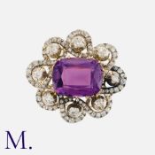 An Antique Amethyst And Diamond Brooch in yellow gold and silver, set with a central cushion