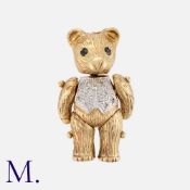 A Teddy Bear Pendant in 9K yellow and white gold with articulated head, arms and legs. Size: 3.2x1.