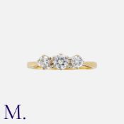 A Diamond Three Stone Ring in 18k yellow gold, set with three round cut diamonds totalling
