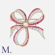 A Natural Saltwater Pearl, Ruby And Diamond Bow Brooch in yellow and white gold, set to the centre