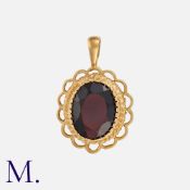 A Garnet Pendant in 9k yellow gold, set with an oval cut garnet within an openwork border.