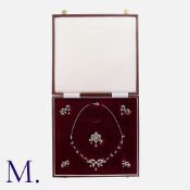 A Diamond Suite in yellow gold and silver. Comprising a necklace, a brooch and a pair of earrings.