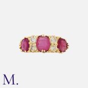 A Vintage Ruby And Diamond Ring in 18k yellow gold, set with three oval cut rubies totalling