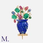 A Gem Set Giardinetto Brooch in yellow gold. Comprising a carved lapis lazuli vase, set with rose
