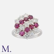 A Ruby and Diamond Cocktail Ring in 18K white gold, set with eight round cut rubies and 11 round
