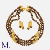 A Tiger's Eye Necklace And Earring Suite in yellow gold, comprising three rows of polished tigers