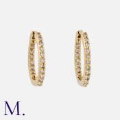 A Pair Of Diamond Hoop Earrings in yellow gold. Of hoop design, set with round cut diamonds
