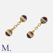 A Pair Of Banded Agate Cufflinks in yellow gold, each comprising two polished, drilled banded