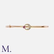 A Ruby and Pearl Crescent Brooch in yellow gold, set with a ruby and half pearls. Unmarked but tests