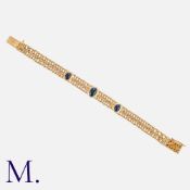 A Cabochon Sapphire Bracelet in yellow gold, comprising two rows of interlocking fancy links set