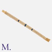 A Cabochon Sapphire Bracelet in yellow gold, comprising two rows of interlocking fancy links set