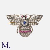 A Ruby, Sapphire and Diamond Bee Brooch in yellow gold and silver, set with round cut rubies,