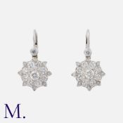 A Pair of Diamond Earrings in 18K white gold each set with bright round brilliant diamonds