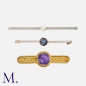 Three Antique 15K Gold Brooches in yellow and white gold. The first a Victorian-era amethyst