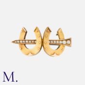 An Antique Equestrian Horseshoe and Nail Brooch in 15 carat gold, designed as a pearl set nail