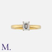 A Diamond Solitaire Ring in 18k yellow gold, set with an emerald cut diamond of approximate 0.
