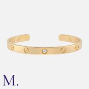 CARTIER, Love Bracelet, One Diamond Cuff Bracelet in 18k yellow gold. Of open cuff design, set