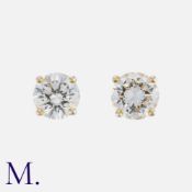 A Pair Of Diamond Stud Earrings in 18k yellow gold, each set with a round brilliant cut diamond of