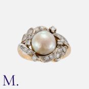 A Pearl And Diamond Ring in yellow gold, set with a principal pearl of approximately 9.7mm, accented