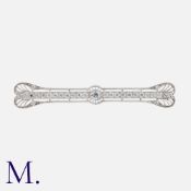 SPAULDING & CO. A Diamond Bar Brooch in whit gold, the pierced, openwork bar set with a row of round