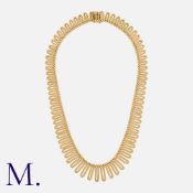A Gold Fringe Necklace in 18k yellow gold, comprising a fringe of textured links. Full British