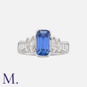 A Sapphire and Diamond Ring in platinum, set with a principal elongated step cut sapphire of
