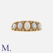 An Opal And Diamond Five Stone Ring in 18k yellow gold, set with five graduated cabochon opals,