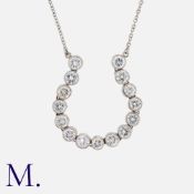 A Diamond Pendant in platinum, designed as a horseshoe set with round cut diamonds totalling