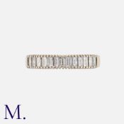 A Diamond Half Eternity Ring in 18k yellow gold, set with a row of baguette cut diamonds totalling