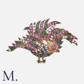 A Gem-Set Bird Brooch in yellow gold, designed as a bird set with round cut rubies, emeralds,