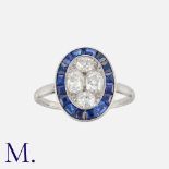 A Sapphire and Diamond Target Ring in platinum, set centrally with four old cut diamonds within a