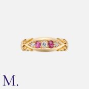 A Ruby And Diamond Five Stone Gypsy Ring in 18k yellow gold, the stylised and set with three round
