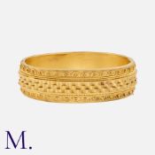 A Victorian, Etruscan Revival Bangle in yellow gold, comprising three undulating ribbon motifs to