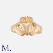 A Claddagh Ring in yellow gold, comprising two hands embracing a heart, representing the eternal
