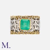 An Emerald and Diamond Ring in 18k yellow and white gold, set with a step cut emerald of
