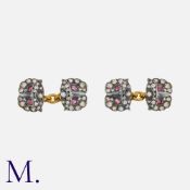 A Pair of Ruby and Diamond Owl Cufflinks in yellow gold and silver, each with two owl's faces set