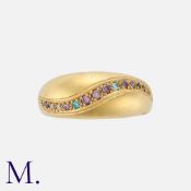 A Gem-set Bombé Ring in 18k yellow gold, set with an undulating row of coloured stones. Marked