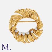 Van Cleef And Arpels, A Diamond Brooch in 14k yellow gold, of abstract, circular design, set with