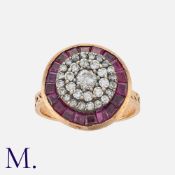 A Ruby and Diamond Target Ring in rose gold, set with three rows of round cut diamonds to the centre