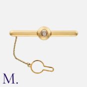 CHOPARD, A Happy Diamonds Tie Clip in 18k yellow gold comprising a freely moving round brilliant cut