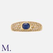 A Vintage Sapphire and Diamond Ring in yellow gold, set with an oval cut sapphire of approximately