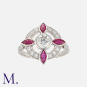 A Ruby and Diamond Ring in platinum, set with a principal transitional round cut diamond (weighing