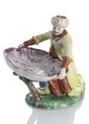 CRUET IN THE SHAPE OF A TURK WITH A SHELL DISH
