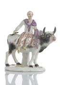 A PEASANT GIRL RIDING AN OX