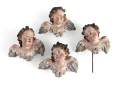 A SET OF FOUR WINGED PUTTO HEADS