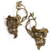 A PAIR OF GILT AND SILVERED WALL CONSOLES WITH WINGED DRAGONS