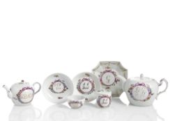 TWO TEAPOTS, TWO CUPS WITH SAUCERS AND A SMALL DISH