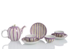 A TEAPOT AND THREE CUPS AND SAUCERS